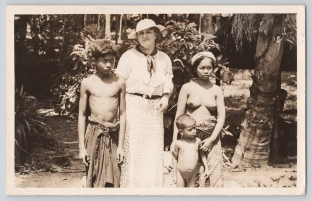 Postcard RPPC Bali Balinese Family Topless Posing With Lady In Near Home Vintage