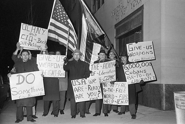 ANTI CASTRO CUBANS protest across street from a hotel where Pr- 1961 ...