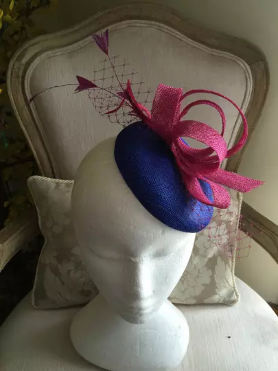 Gorgeous royal blue round fascinator with magenta loops, feathers and netting.