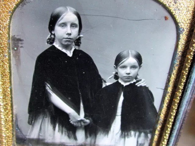 pair of young sisters holding hands daguereotype photograph