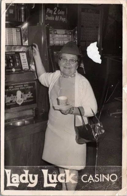 1960s Las Vegas RPPC Photo Postcard LADY LUCK CASINO Little Old Lady at Slots