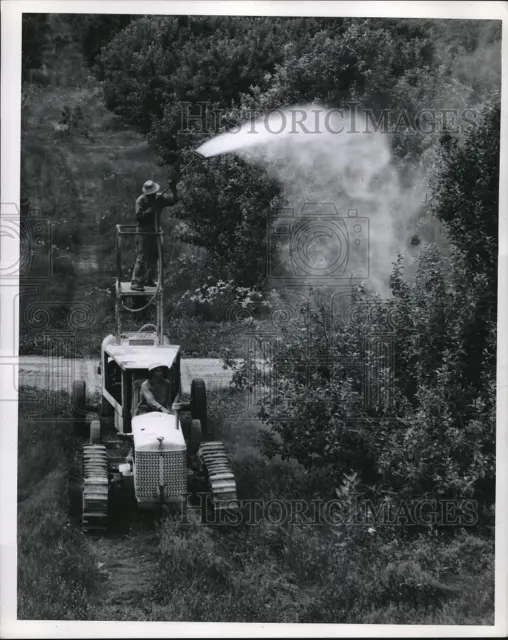Press Photo Michigan apple growers using spray machine to battle insects