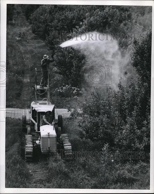 Press Photo Michigan apple growers using spray machine to battle insects