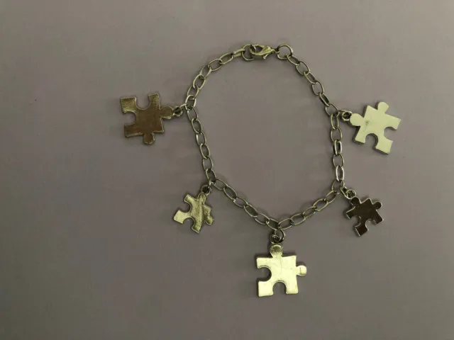silver tone puzzle piece charm bracelet on 8” adj chain Autism Awareness NWOT
