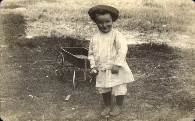 Adorable smiling little boy knickers  ~ pulling toy wagon ~ 1900-1910 Velox RPPC