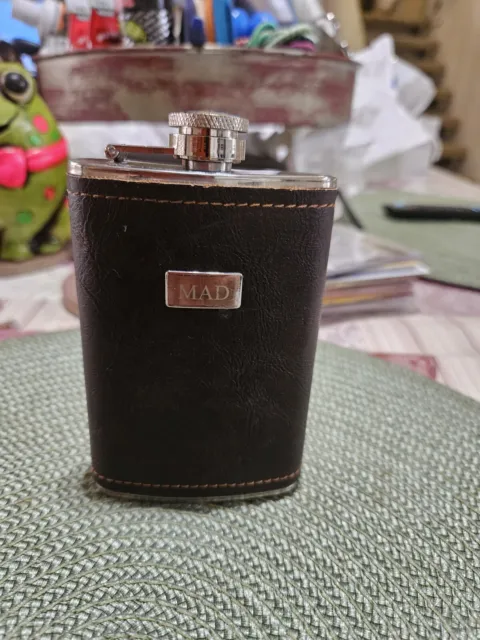 vintage pocket flask. stainless Steel.  4.5 inches Leather wrapped.  MAD on Fron