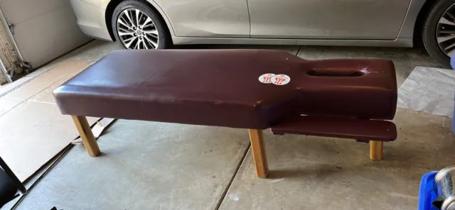 Chiropractic adjusting/exam table. Burgundy or black, full length, local pickup
