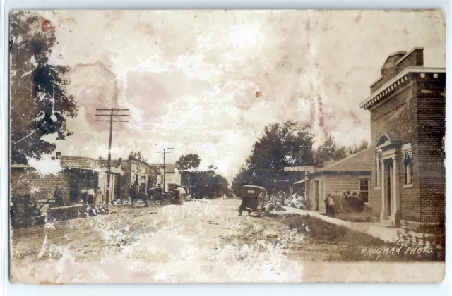 Street scene, bank, auto livery, Coral, Michigan; real photo postcard RPPC