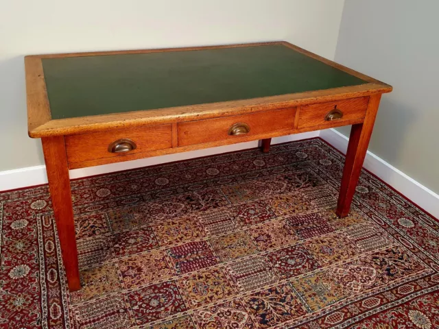 A Solid Oak Government Issue Desk With Hard Green Inlay and Three Draws
