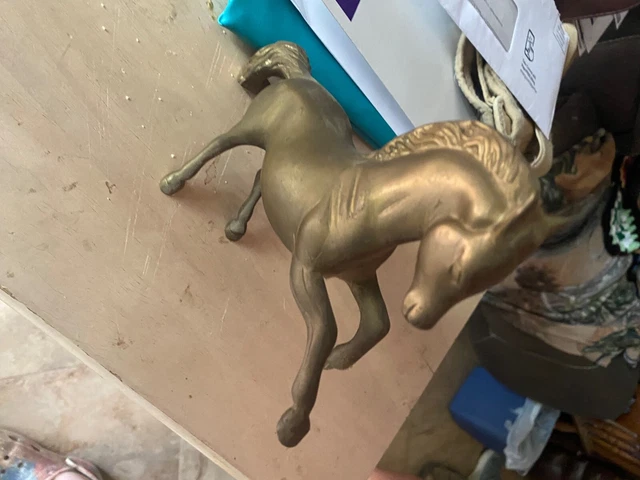 2 horse statues. One winds up and works. Both bronze colored