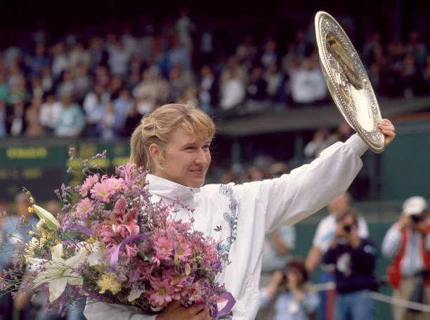 STEFFI GRAF OF Germany lifts the trophy after defeating Martina N - Old