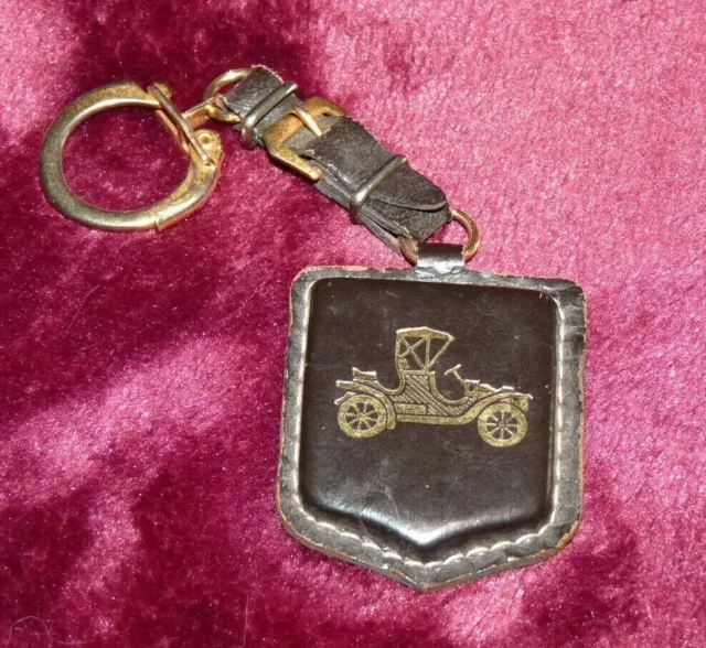 Ancien porte clés en cuir noir Groupe Ancienne Mutuelle motif tacot doré Keyring