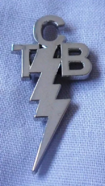 Pretty Green ' Taking Care of Business ' TCB Silver / Nickel coloured pin badge.