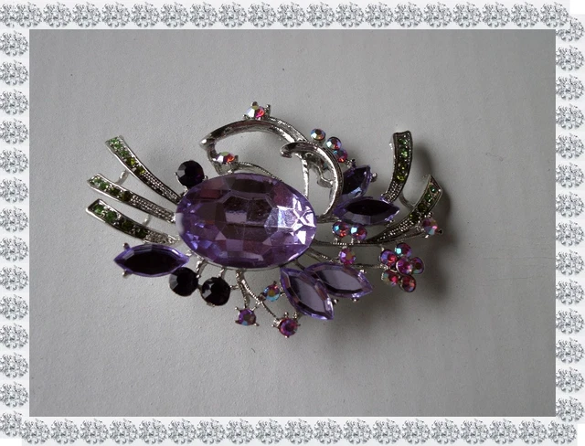 Broche oiseau colibri en métal argenté avec strass bleus et