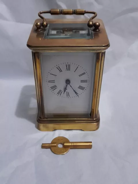 Antique Edwardian brass carriage clock with enamel face.