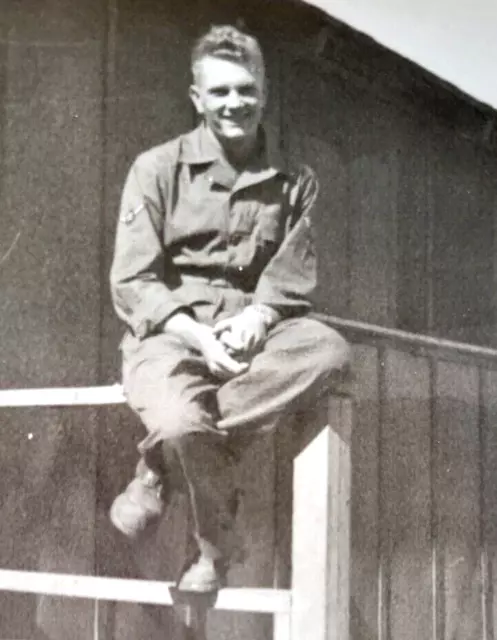 WWII Era US Soldier in Uniform Jump Suit Sitting on Post of Barracks Orig Photo