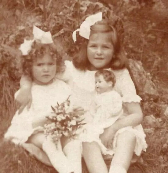 1918 RPPC Little Girls Sisters w Doll Flowers Bows Antique German Postcard