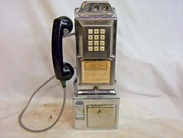 Early 12-button touch tone Automatic Electric chrome 3-slot payphone