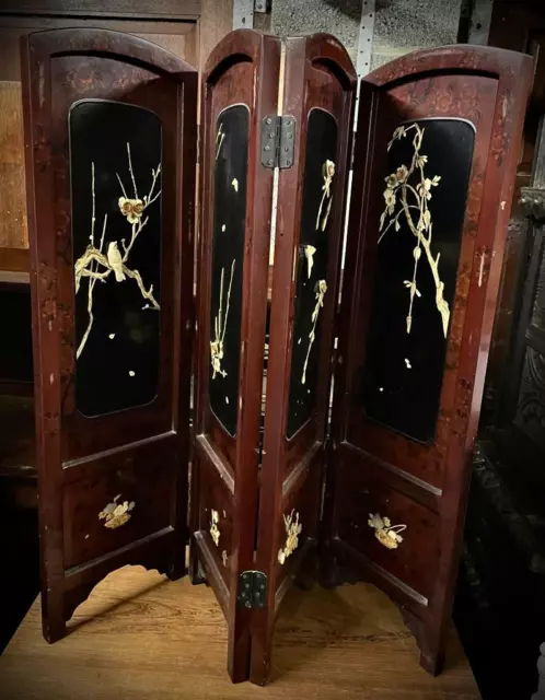 Oriental half height lacquered screen with carved detail