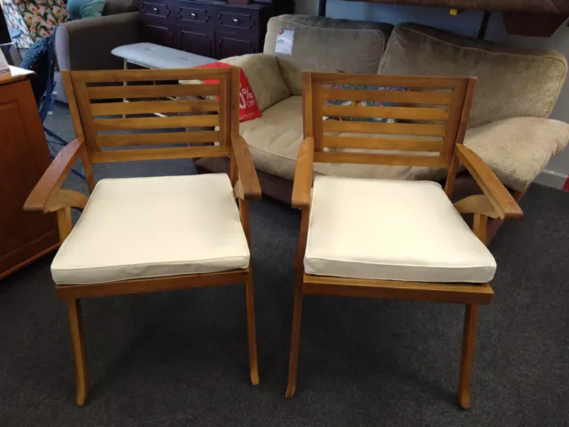 A Pair Of Teak Garden Chairs With Cream Pads CS I07