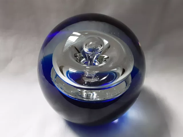 Large Circular Bubble Glass Paperweight With Dark Blue Base.