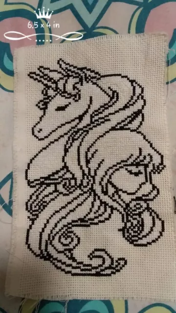 completed unframed cross stitch unicorn and girl
