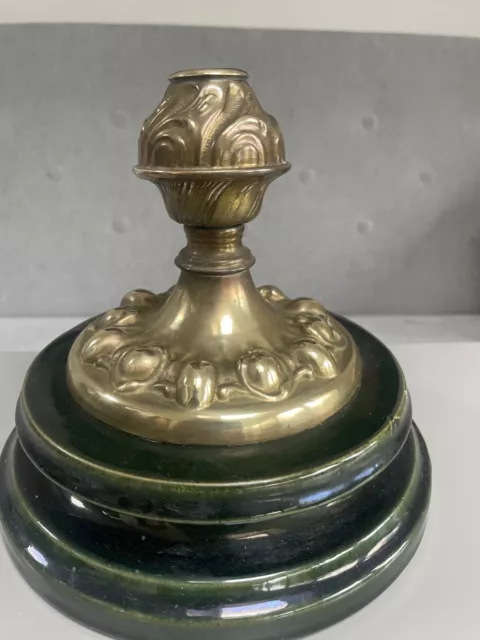 antique brass oil lamp base on black plinth