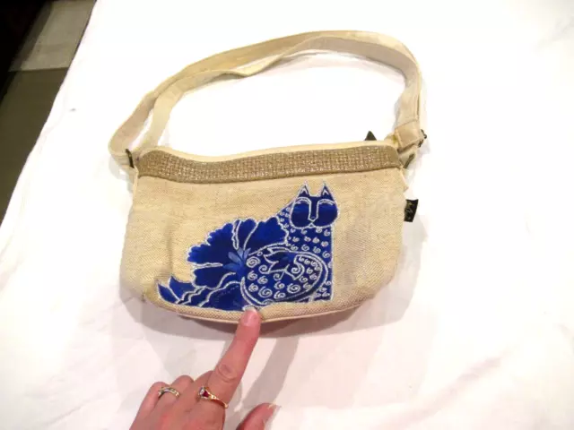 Laurel Burch cream-colored purse with purple mermaid cat, signature zipper pull