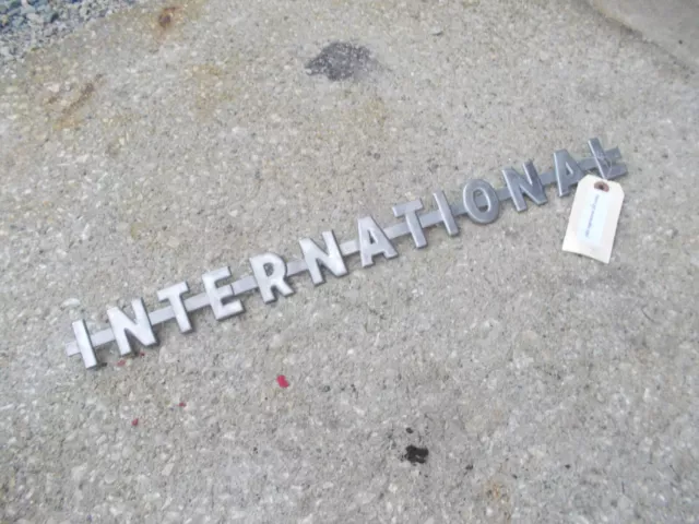 1) International I-N-T-E-R-N-A-T-I-O-N-A-L utility Tractor chrome hood emblem
