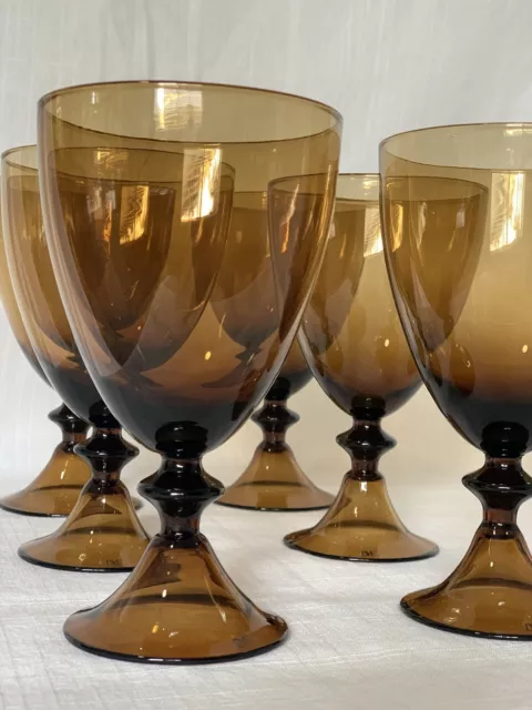 7 Diane von Fürstenberg DVF designed hand blown amber colored wine glasses.