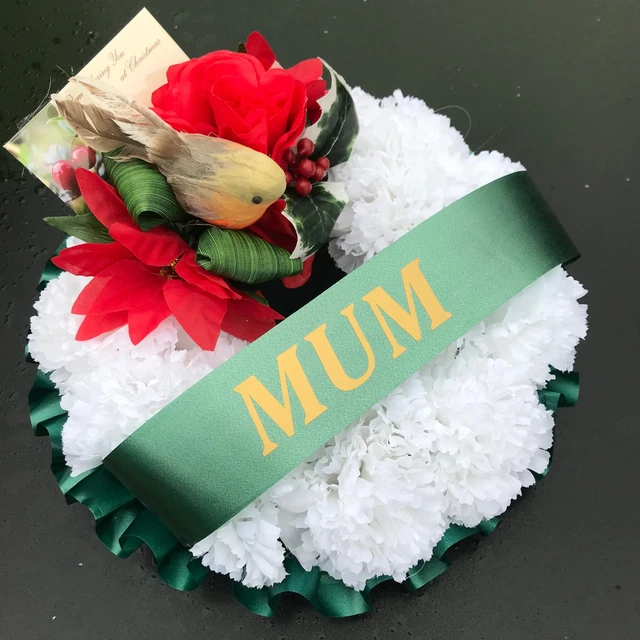 A christmas memorial based posy wreath of red roses and carnations