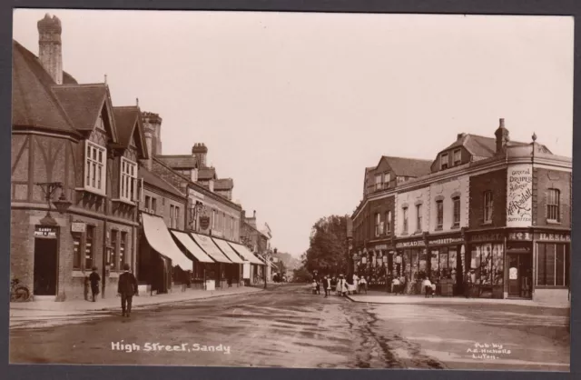 Postcard Sandy nr Bedford old High Street shops Post Office RP Nicholls of Luton