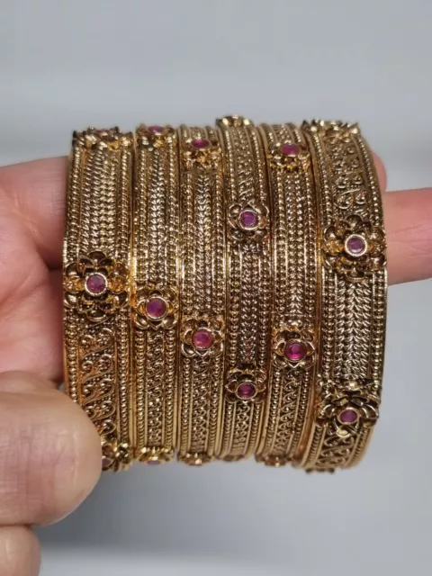 Indian Pakistani 6 piece Gold rajwari bangles set with red stone.