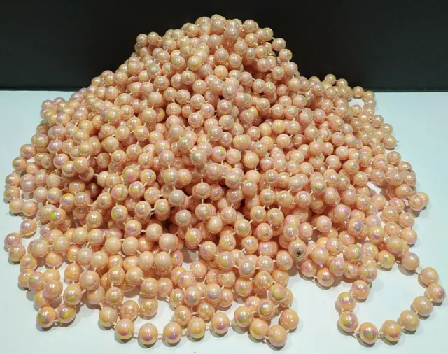 One vintage Iridescent peach Plastic Pearls 9' long