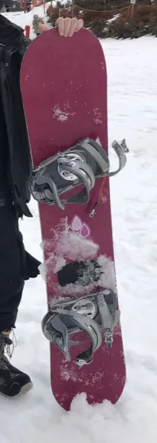 Snowboard in carry bag and boots.