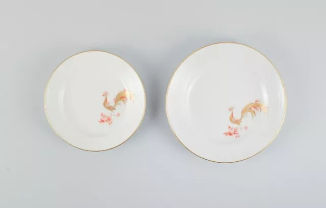 Two rare Art Deco Meissen plates with hand-painted peacocks and gold decoration.