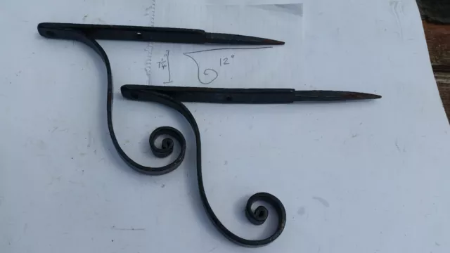 A pair of vintage metal shelf brackets