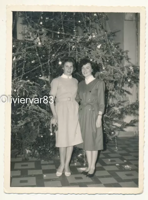Vintage photo - 2 pretty elegant women by huge Christmas tree