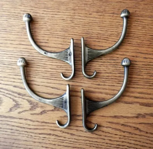 four (4) antiqued brass hall tree hooks