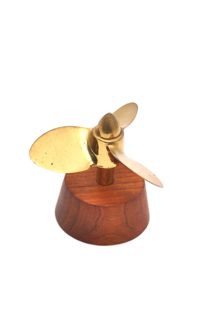 decorative brass propeller on wood base
