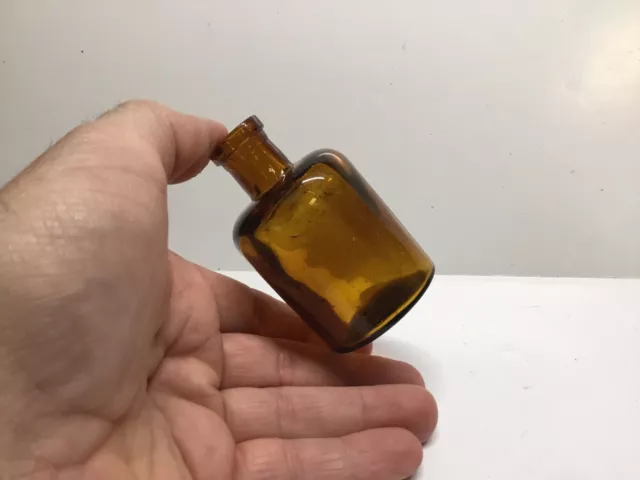 Small Round Antique Amber Chemist / Medicine Bottle.