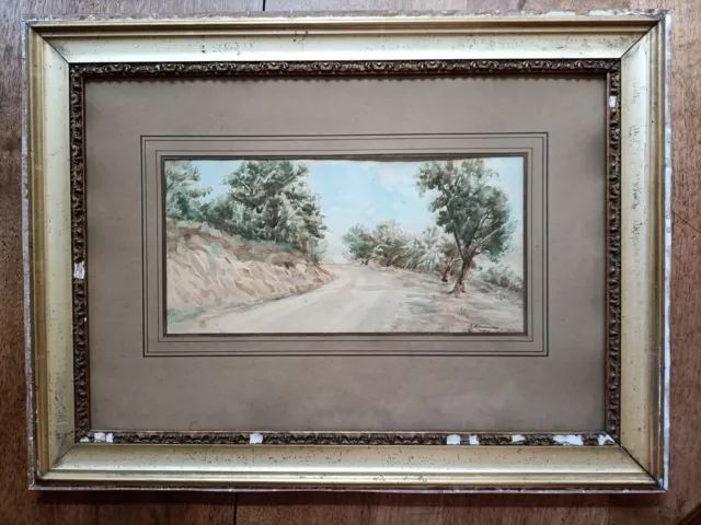 La route, aquarelle signée D. MANOUYRIER et datée de 1904, encadrée sous verre.
