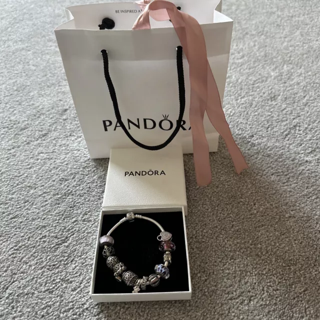 A Beautiful pandora bracelet with charms 20cm. purple/lilac and pink themed
