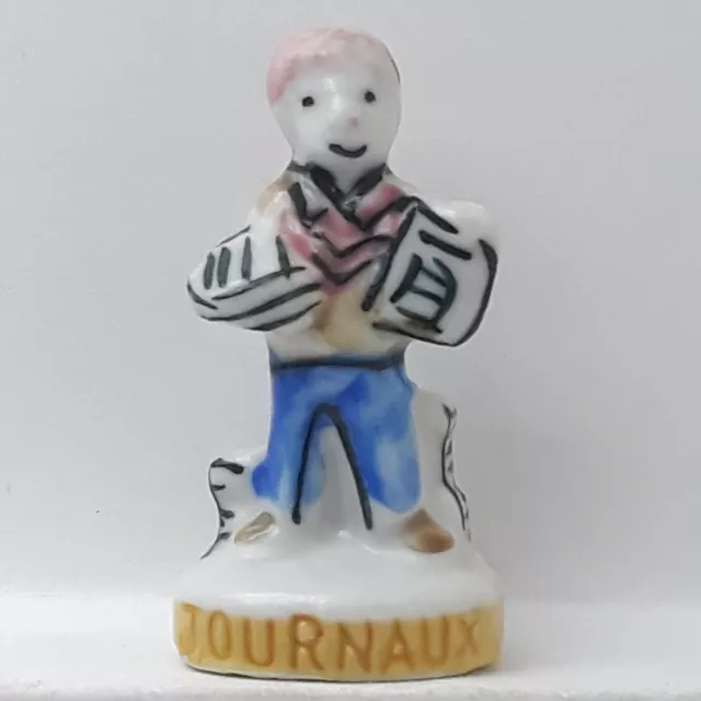 Fève Homme Journaux en porcelaine Nordia 1995 (B21E)