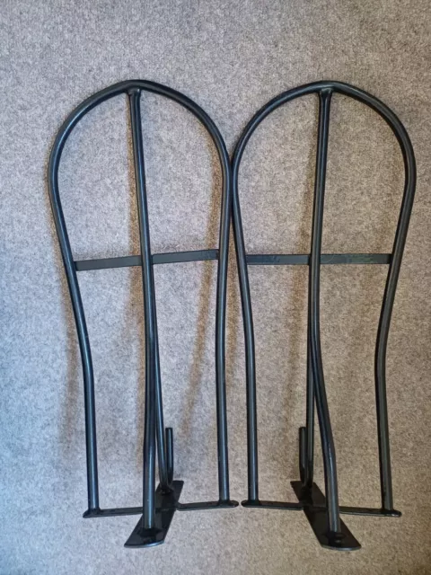 Two wall mounted metal saddle racks in excellent condition