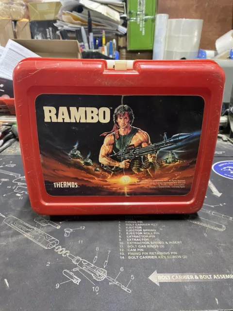 https://www.picclickimg.com/G60AAOSw~NdlBg25/Rambo-1985-Vintage-Red-Plastic-Lunchbox-with-Thermos.webp