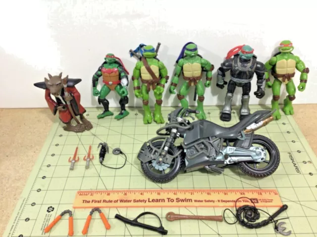 TMNT Teenage Mutant Ninja Turtles motorcycle, weapons, & 6 action figures!