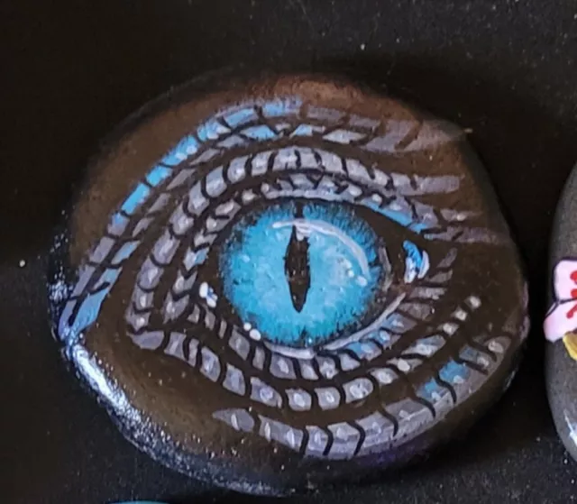 Hand painted dragon's eye rock, with glow in the dark