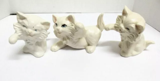 Trio Of White Ceramic Cats, With Blue Eyes Two Are The Same Mold The Tallest Is