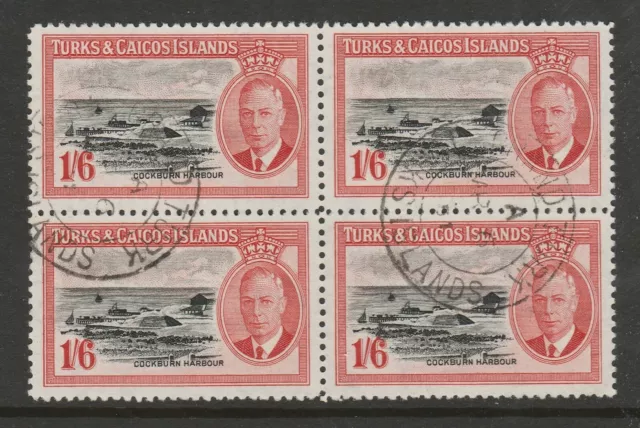 Turks & Caicos Is.1950 1/6d Black & scarlet in block of four SG 230 Fine used.